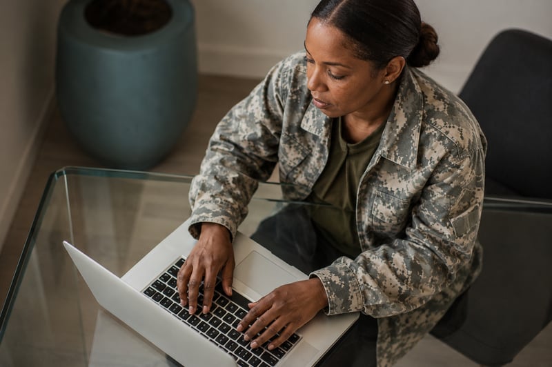 Military Civilian Typing on a Laptop Computer